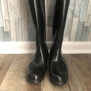 Hunter rain boots. Shinny black tall rubber boot. They are not insulated.